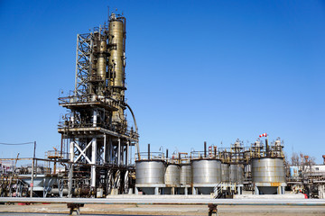 Oil refinery in Russia. equipment and complexes for hydrocarbon processing. Section of technological columns for the manufacture of gasoline, pipelines, tank.