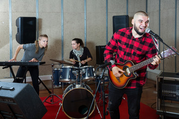 Emotional guy with guitar rehearsing