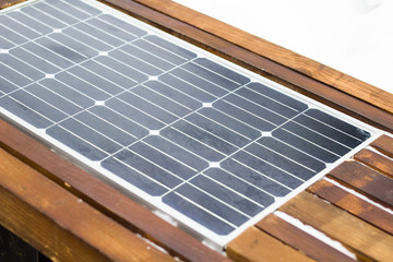 Bench with solar panel on street close-up