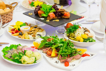 Various cold appetizers on the buffet: seafood, vegetables, meat, delicacies.