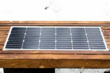 Bench with solar panel on street close-up