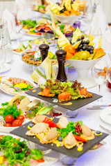 Delicacies, snacks and fruit on the festive table in the restaurant. Celebration. Catering. Banquet table.