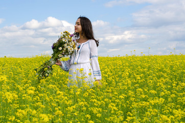 Fototapeta premium little girl in the flowers field