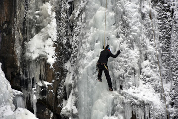 Ice climber on the frozen Boyana Waterfall in Vitosha Mountain near Sofia City, Bulgaria