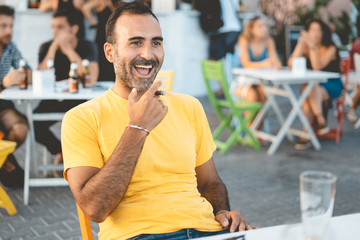 portrait of mid aged adult person laughing with friends on a cafe table