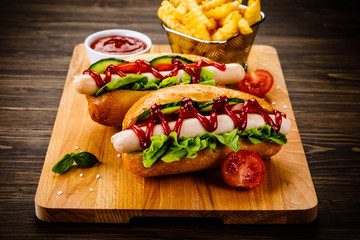 Hot dogs and french fries on cutting board