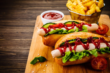 Hot dogs and french fries on cutting board