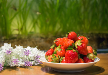Strawberries in ceramic bowl. Fresh nice strawberries on wooden table. Juice strawberry - Image