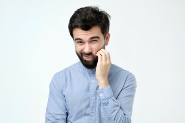 Worried suspicious mature hispanic man isolated against white studio background