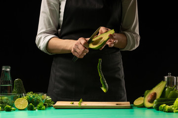 The chef prepares fresh green fresh dietically, detox. Healthy and clean nutrition, diet and sport. Background for design