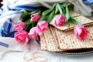Obraz na płótnie Canvas Matzo and bouquet of flowers .Pesah celebration concept (jewish Passover holiday)-