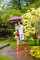 Beautiful smiling middle-aged woman with an umbrella