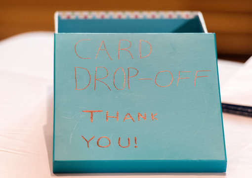 a blue card drop-off box with the words thank you is shown during a party