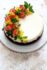 Fototapeta na wymiar Homemade cheesecake with fresh strawberries and carambola 