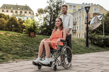 Charming young female sitting on her wheelchair