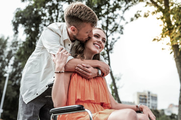Pleased disabled girl enjoying the moment with partner