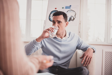 Concentrated young man listening to his therapist