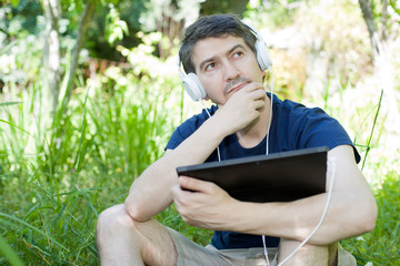 man relaxing with tablet pc