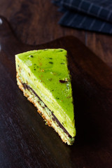 Matcha Green Tea Layer Cake Slice on Dark Wooden Board.