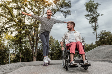 Joyful female person standing on her skateboard