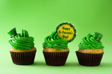 Obraz na płótnie Canvas St. Patrick's Day cupcakes on green background. 