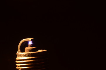 Macro view of spark plug that ignites a gas mixture