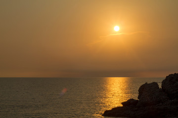 Blue and orange sunset and rocky beach in Drymades Dhermi Albania