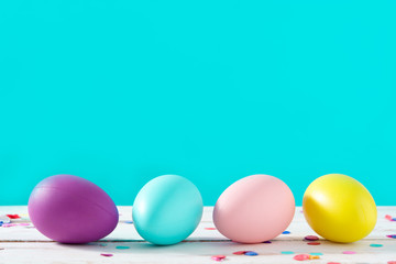 Easter holidays concept with colorful easter eggs on blue background. Copyspace