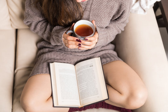Woman Spending Her Morning With Novel And Tea