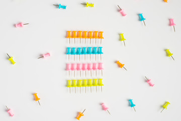 Colored pushpins on white. Office accessories. Office supplies on white. 