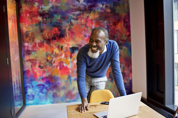 Senior black creative professional presenting in a meeting