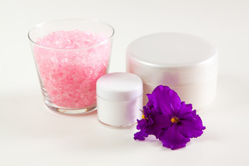 moisturizer, sea salt and violet on a white background