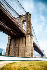 Brooklyn Bridge closeup in the morning with colorful cloud over East River in Lower Manhattan in...