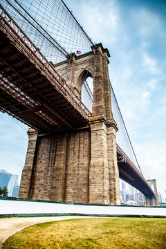 Fototapeta Brooklyn Bridge closeup in the morning with colorful cloud over East River in Lower Manhattan in New York City