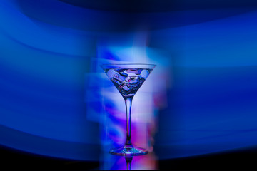 cocktail drink in the club on the table in the rays of spotlights