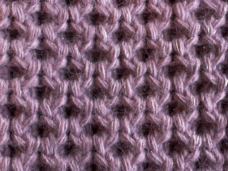 Knitted fabric. Large handmade knitting of lilac yarn. For textures, backgrounds.