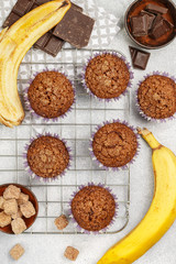 Chocolate muffins with banana and sugar crust on the cooking grill. Fresh homemade pastry. Selective focus, top view