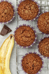 Chocolate muffins with banana and sugar crust on the cooking grill. Fresh homemade pastry. Selective focus, top view