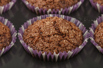 Baking delicious chocolate muffins with banana and sugar crust. Fresh homemade pastry. Selective focus