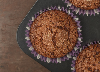 Baking delicious chocolate muffins with banana and sugar crust. Fresh homemade pastry. Selective focus