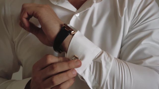 the morning of the groom, a handsome guy in a suit with a bow tie, slow motion