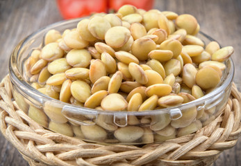 Raw lentils on wooden table closeup