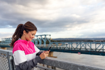Fitness woman on mobile smart phone app tracking progress