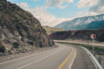 Steep turn of the road on the mountain serpentine. Mountain landscapes of the Chui tract, Altai. Valley Chuya.