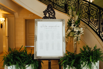 Original vintage white board with decoration, candles and ribbons and a guest list,