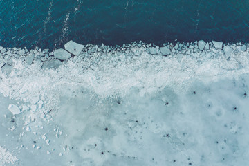 Glacier Lagoon with icebergs from above. Aerial View. Cracked Ice from drone view. Background texture concept. © Curioso.Photography