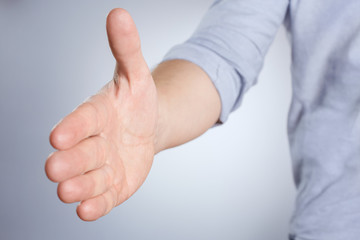 Greeting hand on gray background