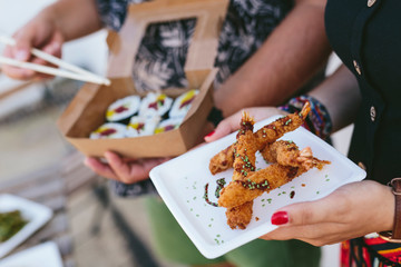 Crop people with delicious street food