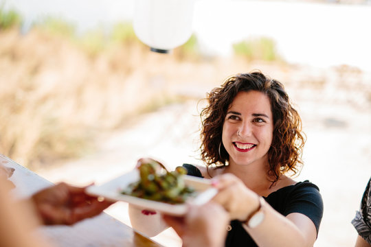 Content woman receiving meal in food truck