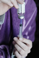 Hand holding syringe and vaccine. Syringe medical injection Liquid drug or narcotic in hand